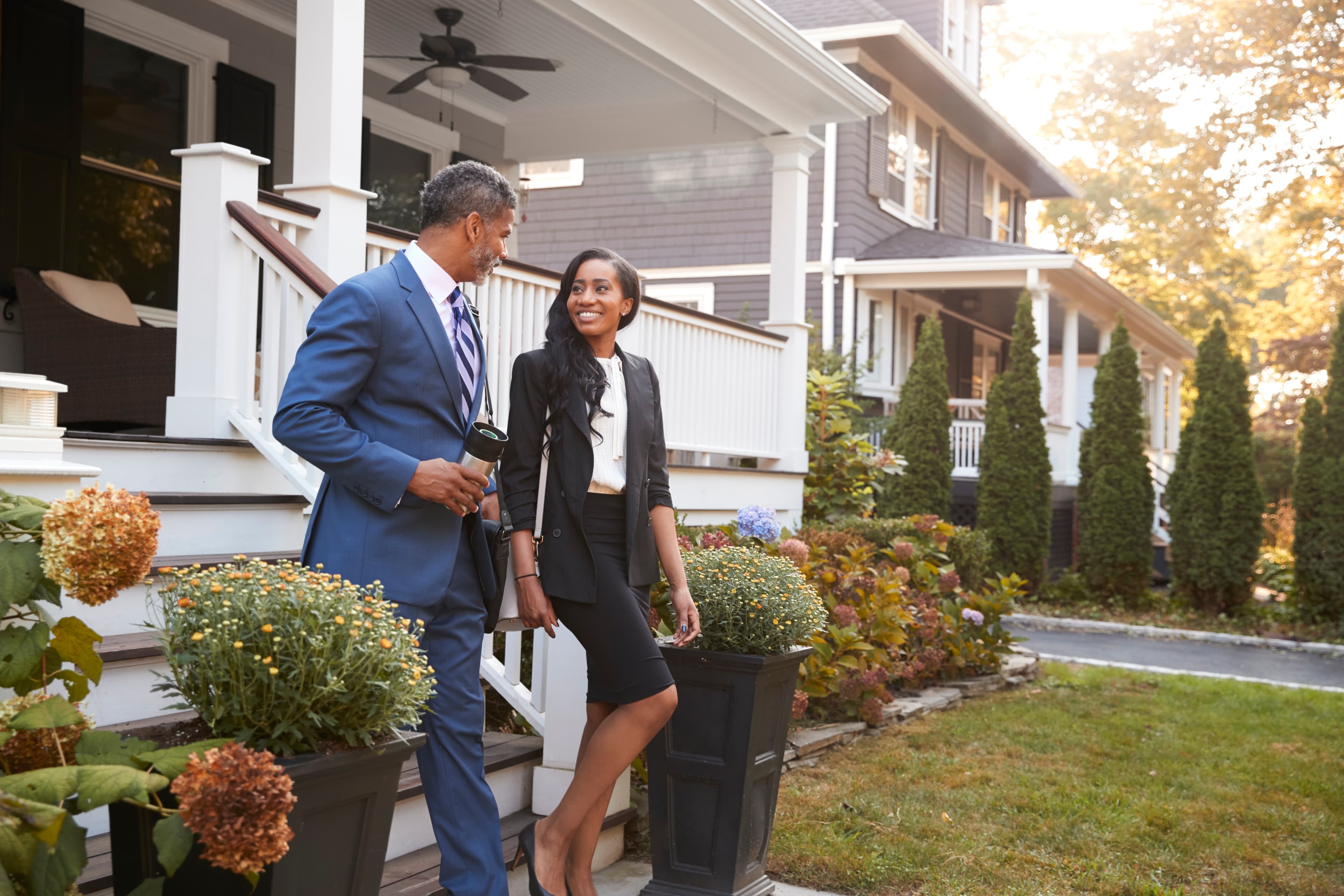 Couple leaving suburban house for commute