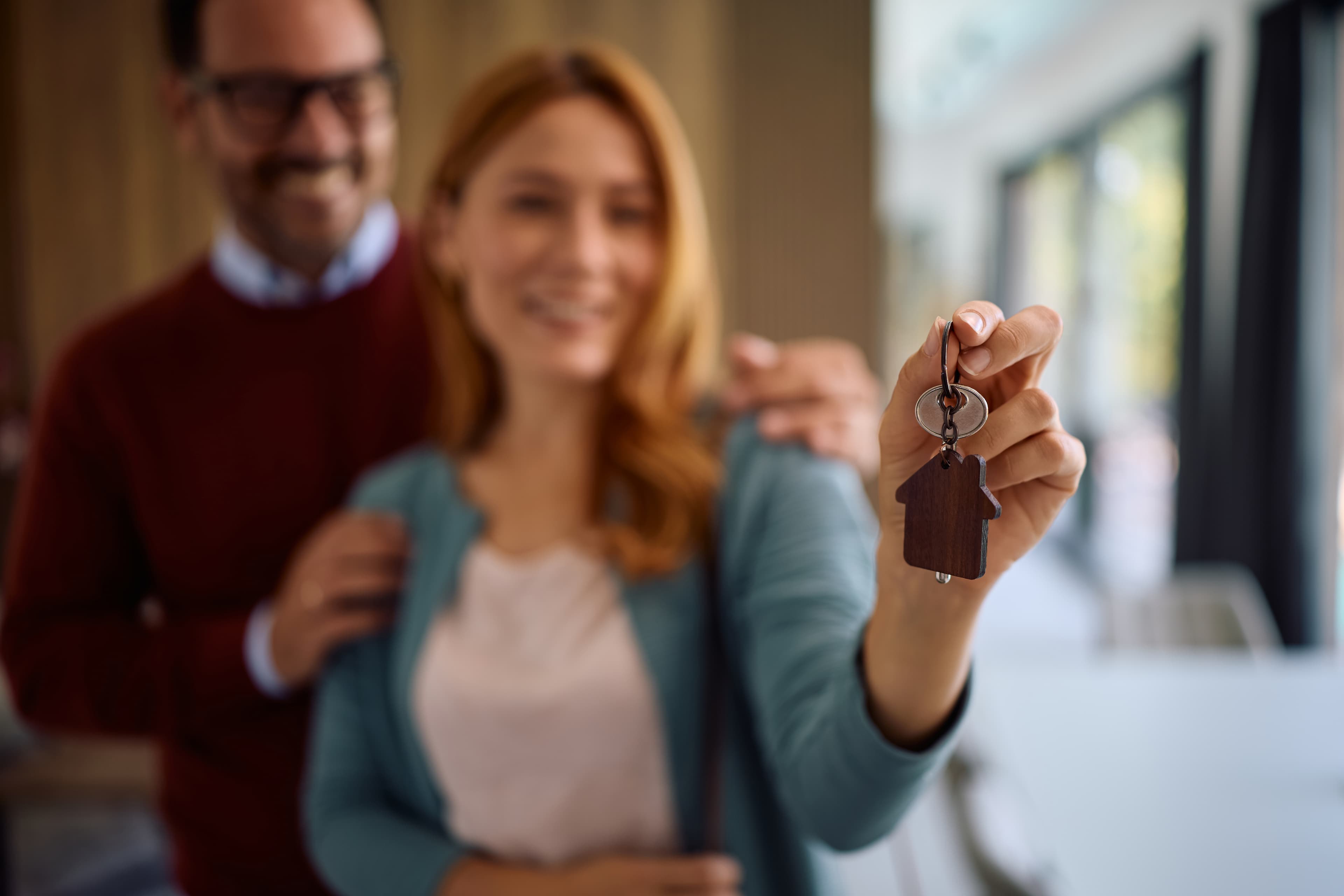 Woman holding keys to her new home