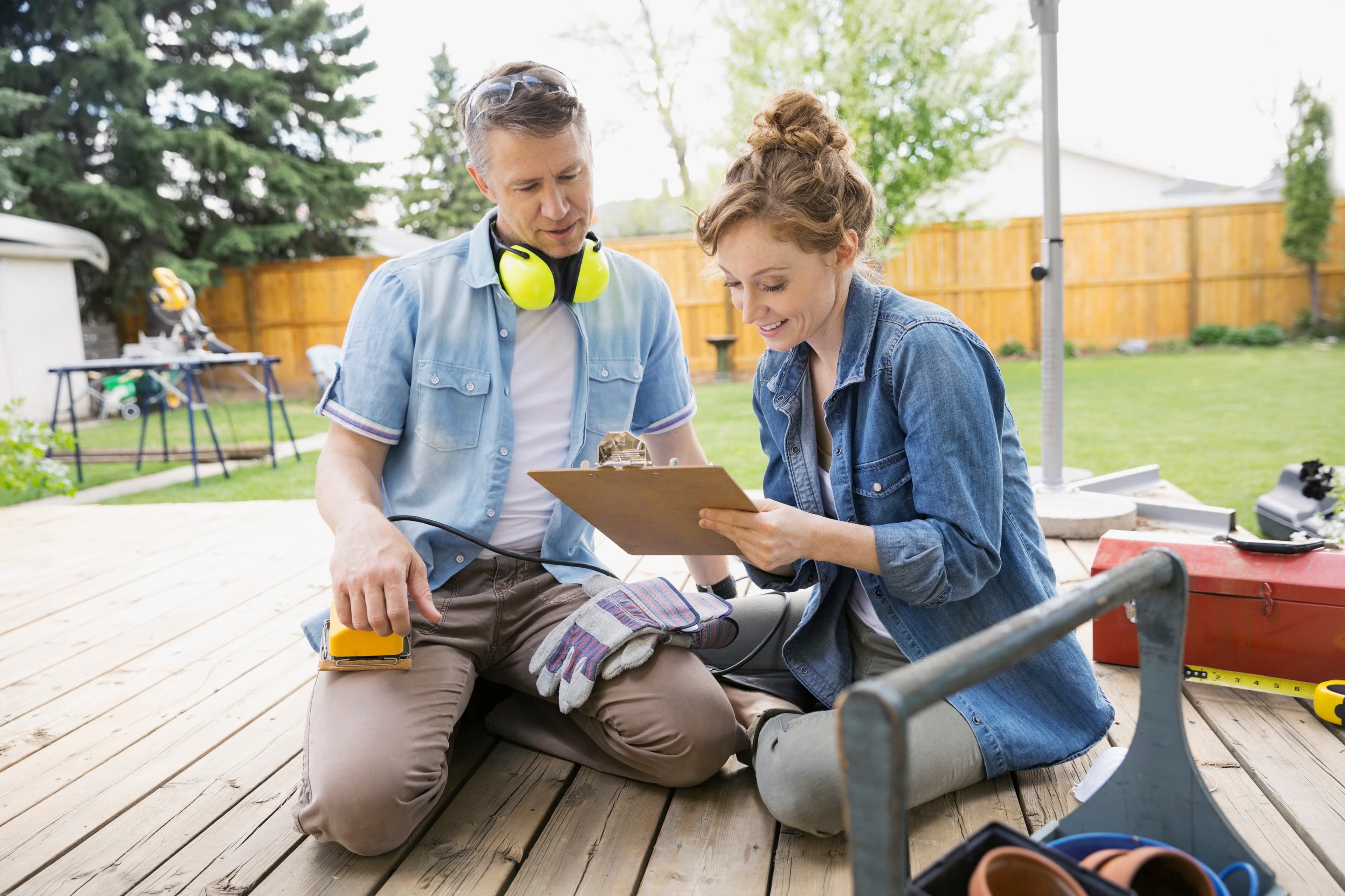 Couple preparing for backyard deck project