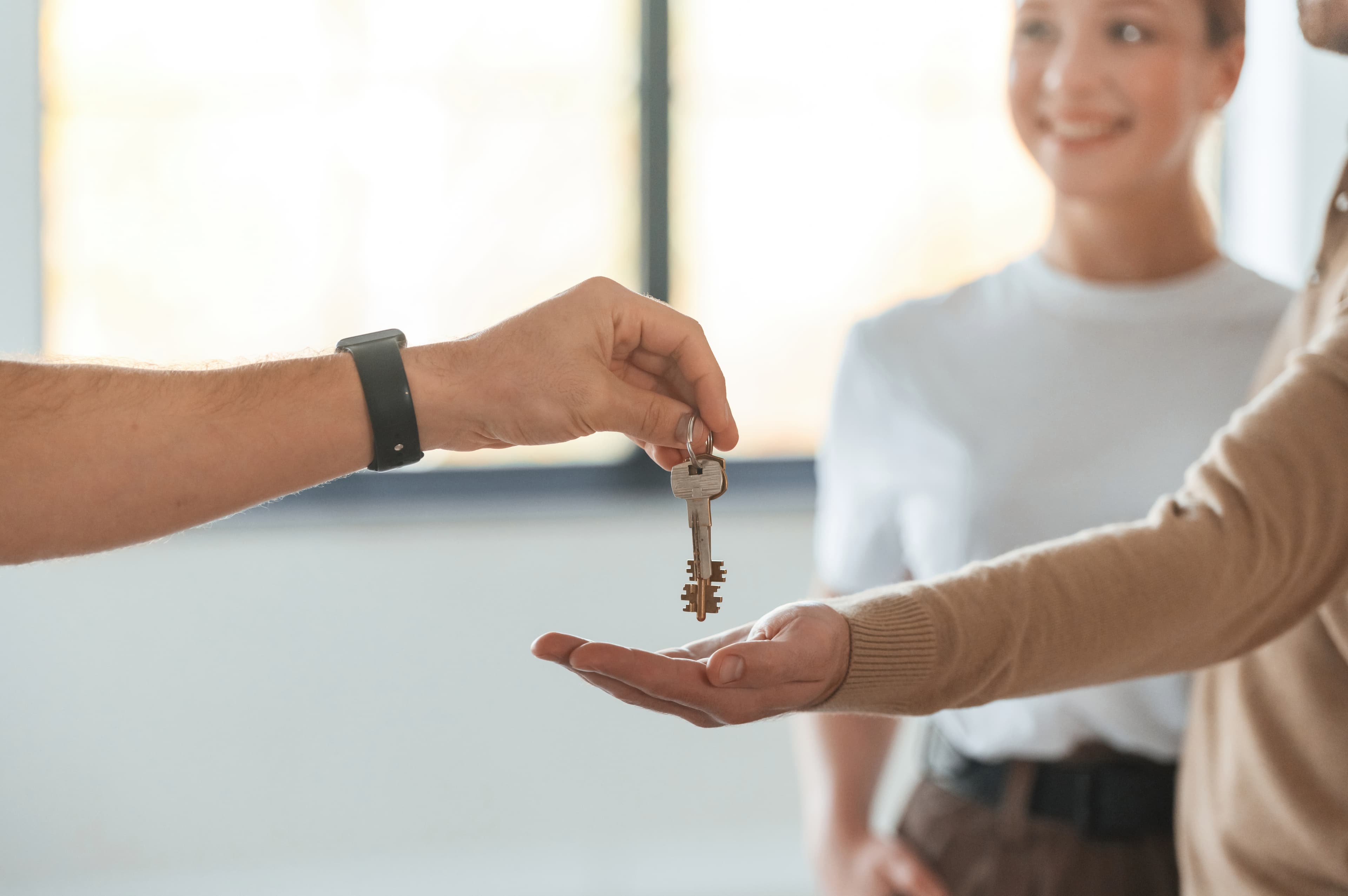 Happy customers receiving keys to their new place