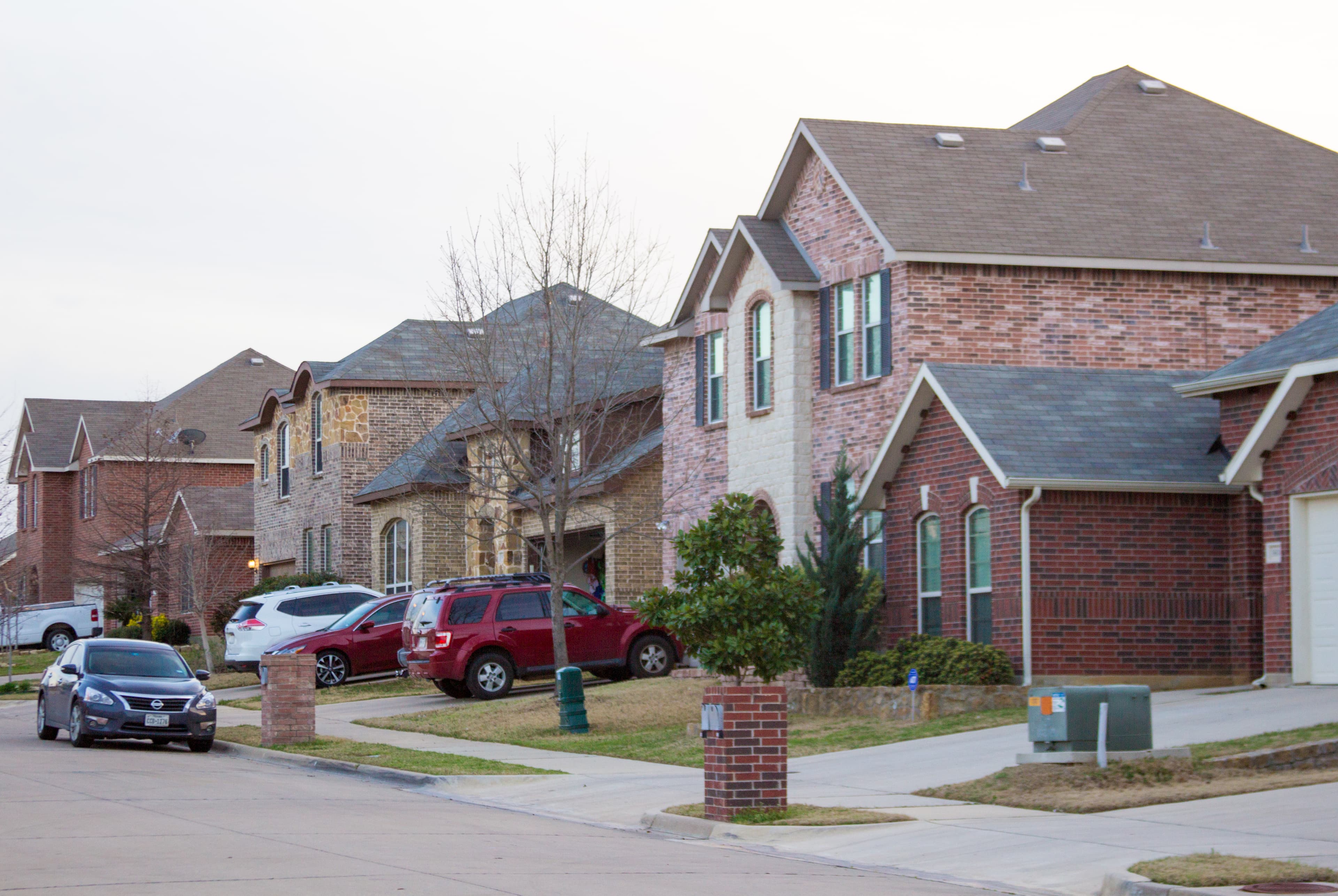Neighborhood street and front yards at dusk