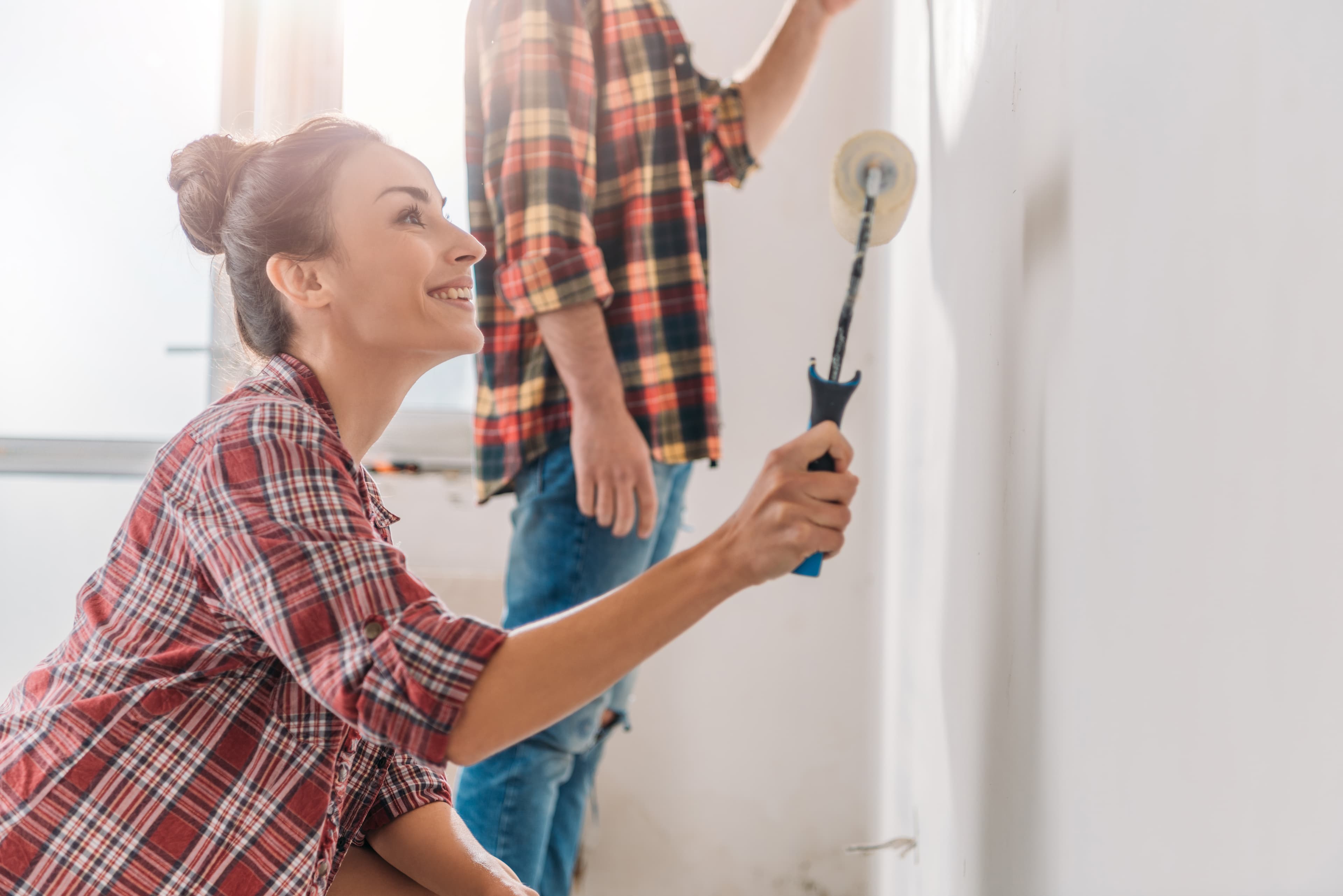 Young woman ready to paint with roller