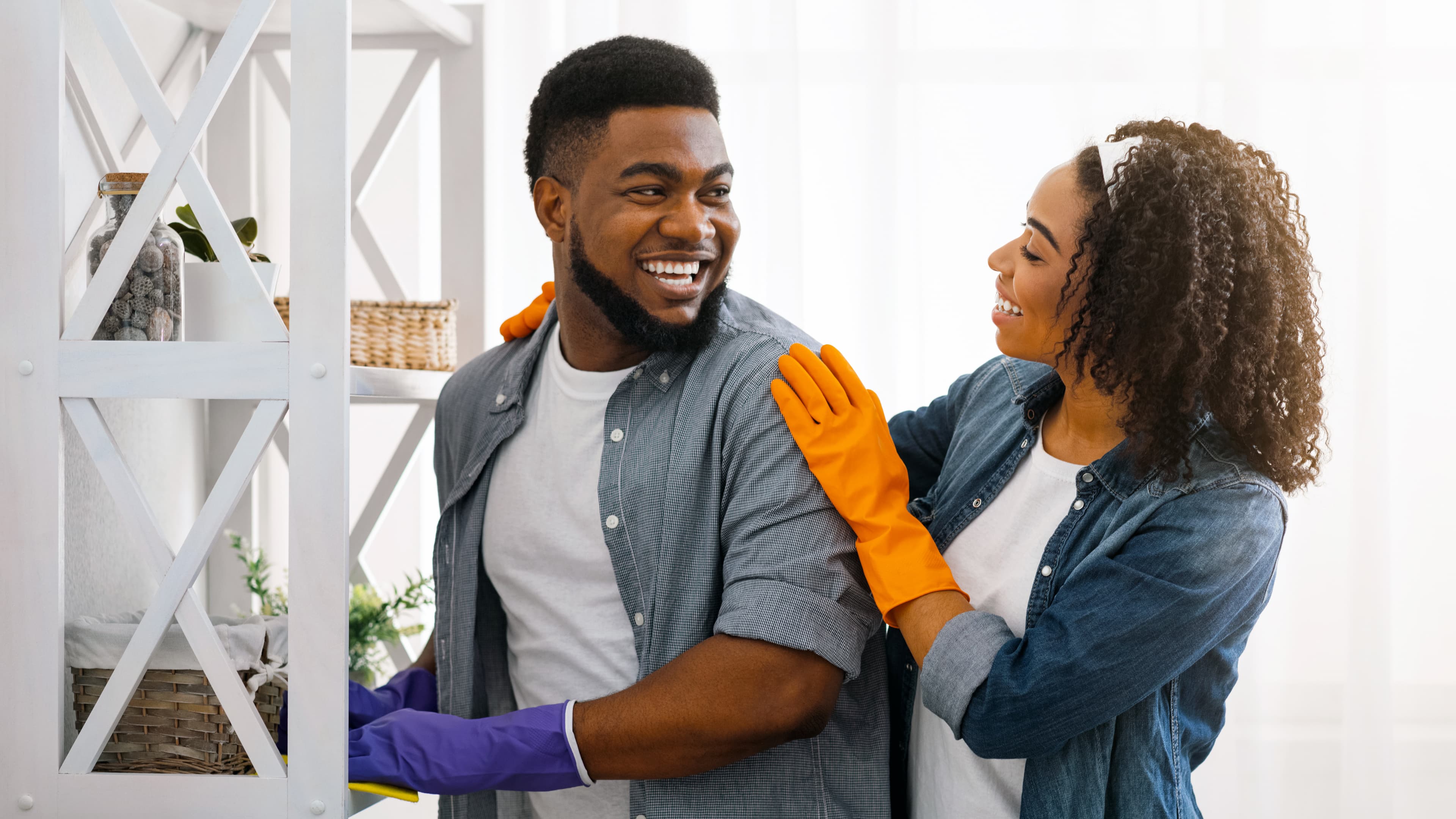 Young couple cleaning their home together